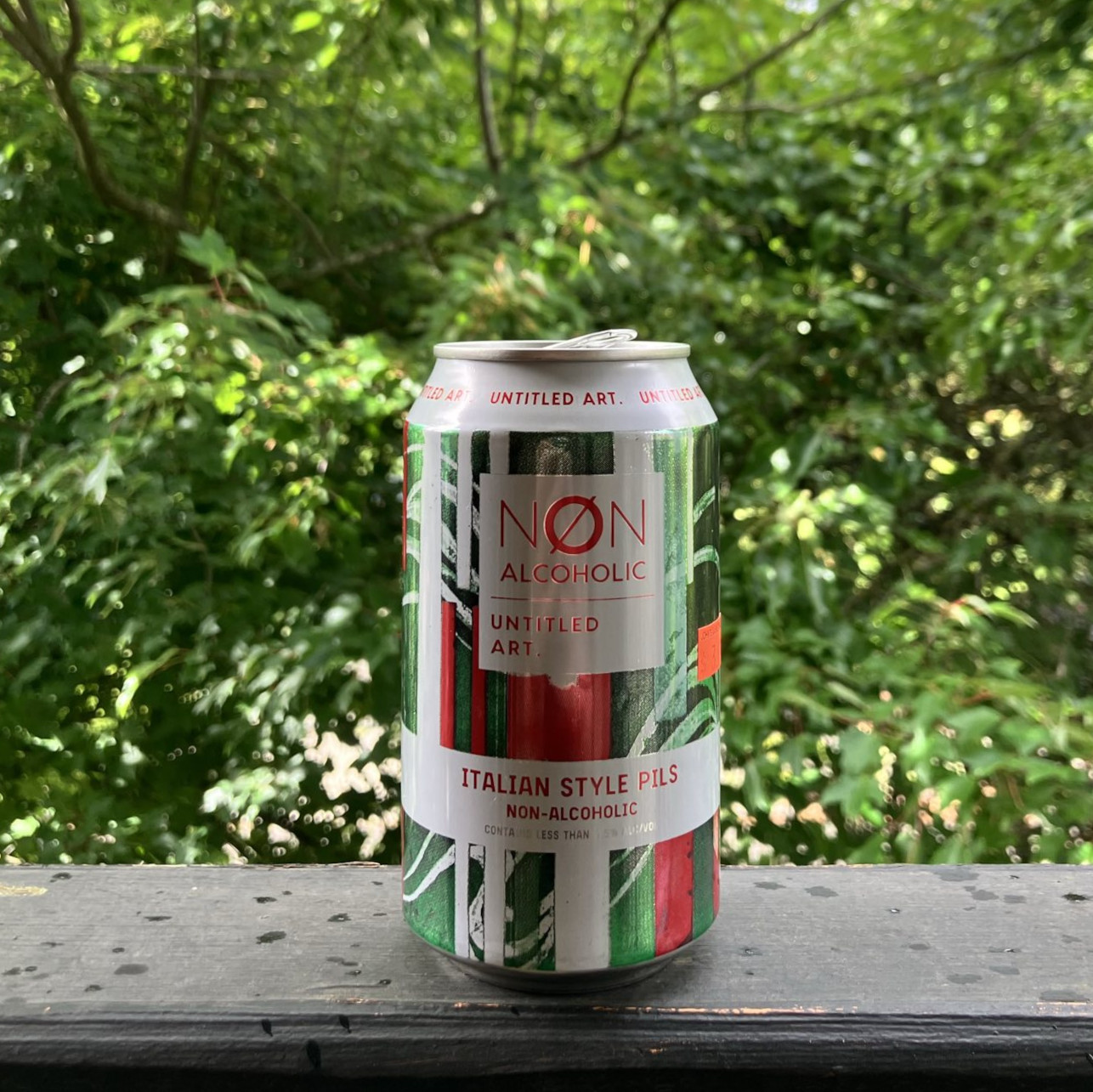 Untitled Art&rsquo;s Italian-style Pils, in a 12 ounce can, on a balcony railing